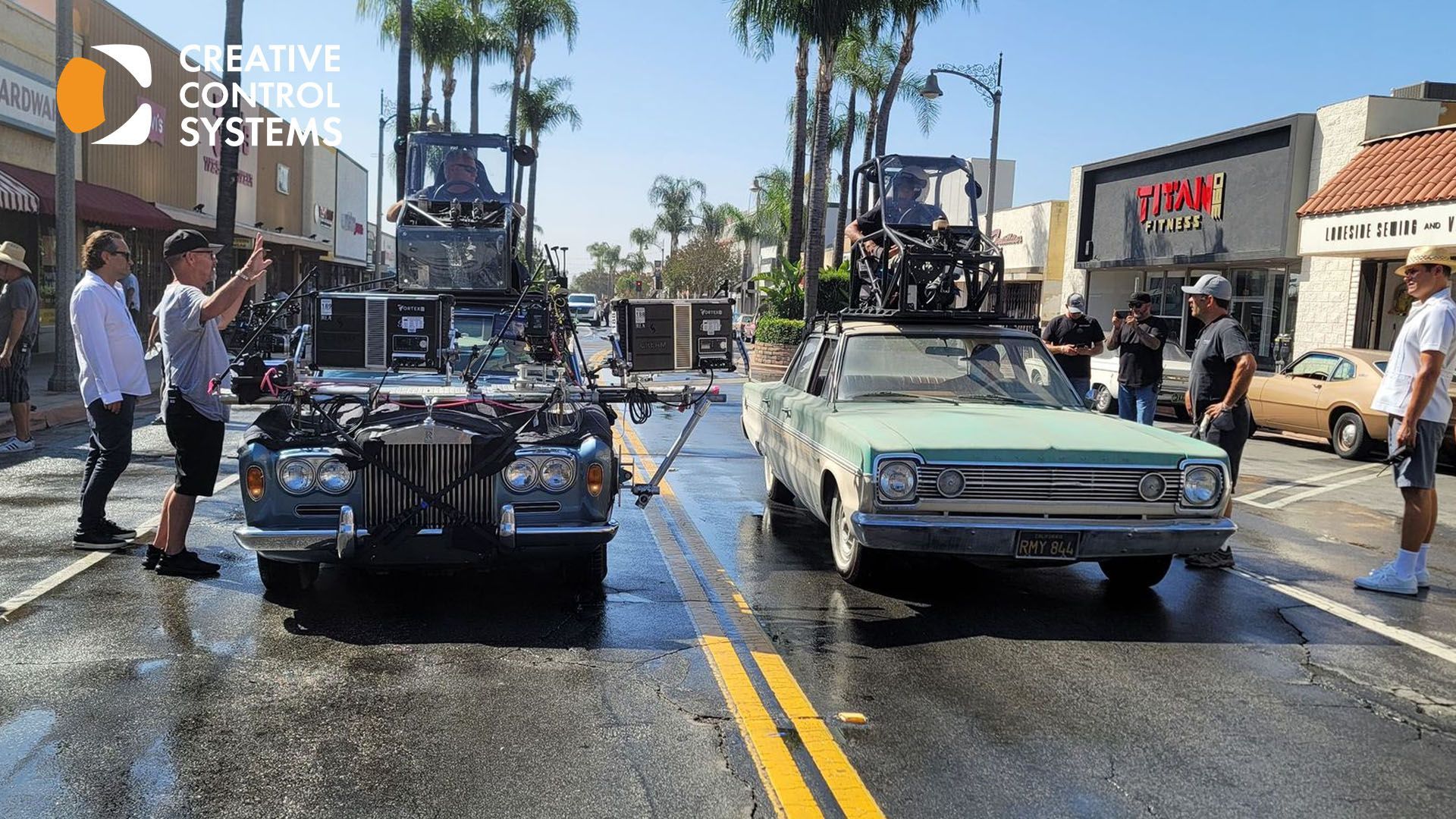 Two cars with individuals standing on top, captured in unstable and shaky footage, affecting overall production quality.