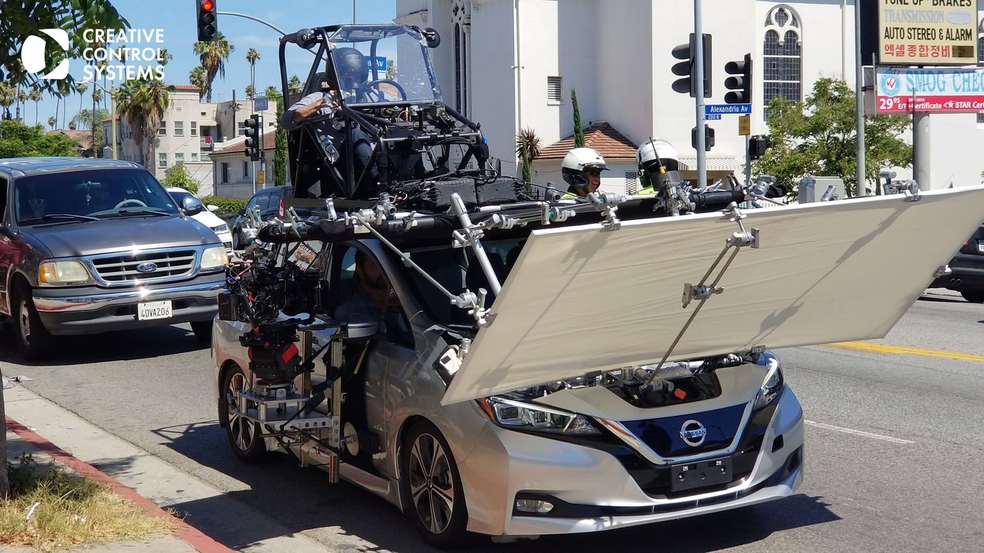 A car equipped with a camera on its roof, showcasing advanced technology for remote-controlled filming.