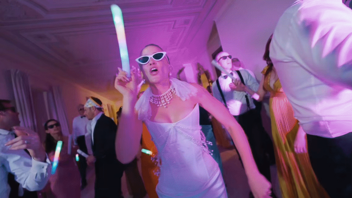 Bride dancing at luxury wedding party in Italy with guests celebrating destination wedding