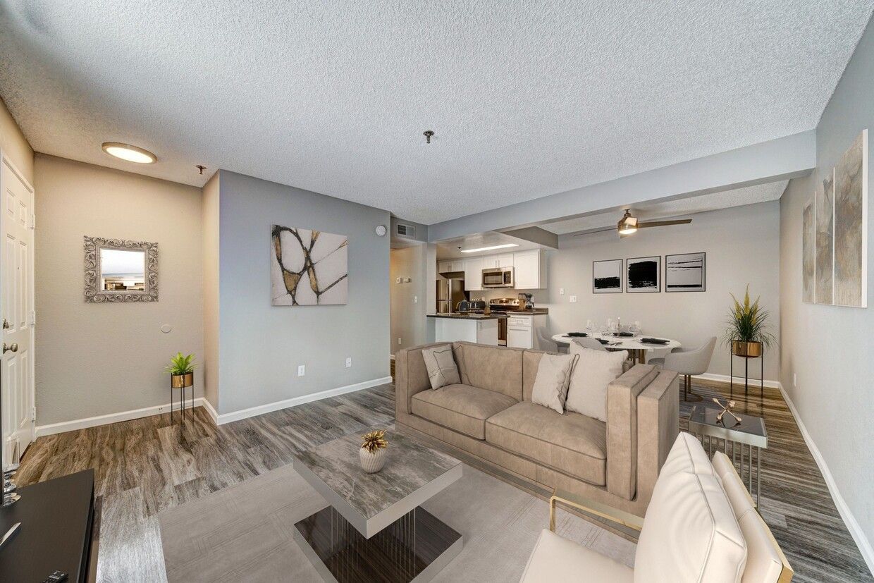 modern living room with a sofa, coffee table, bench, chair, tv and onlooking to a patio