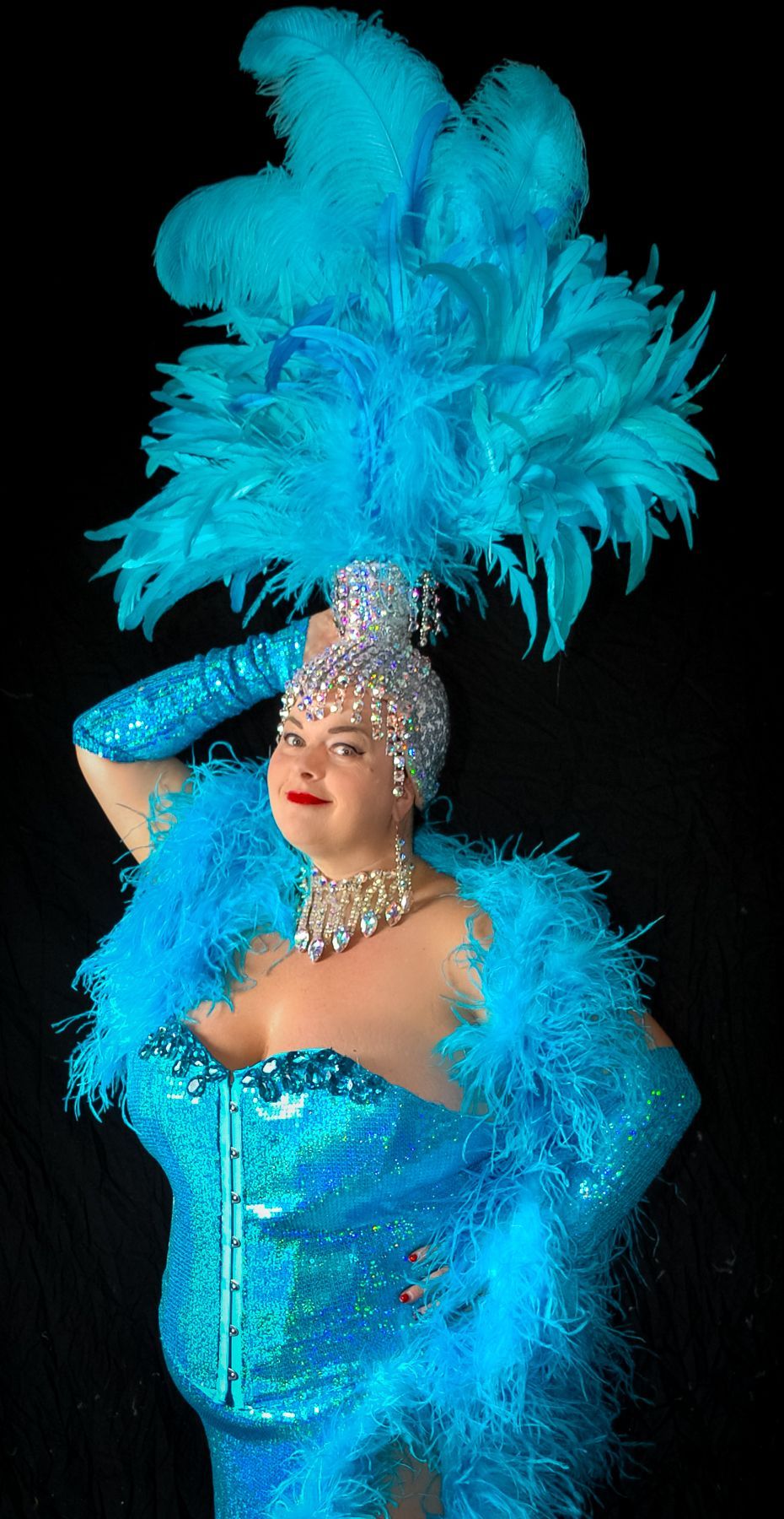 A plus size woman in an authentic Las Vegas showgirls costume.