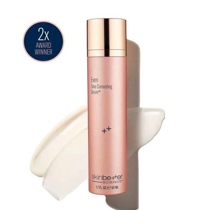 Pink skincare serum bottle with gold cap and swatch of product. 