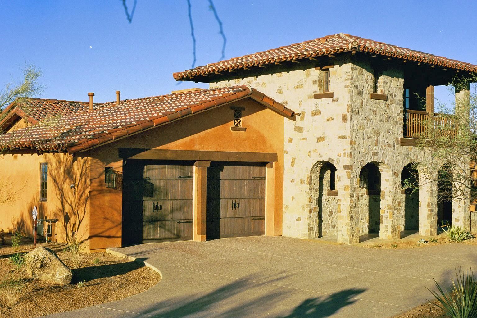 A large house with arches and a tiled roof