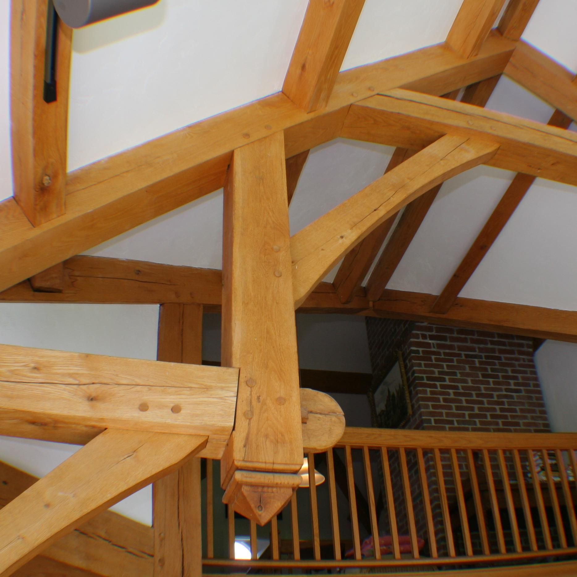 A wooden structure with a brick chimney in the background