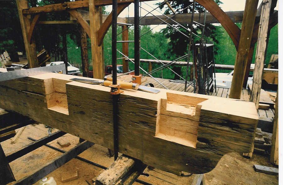 A large piece of wood is being cut with a saw
