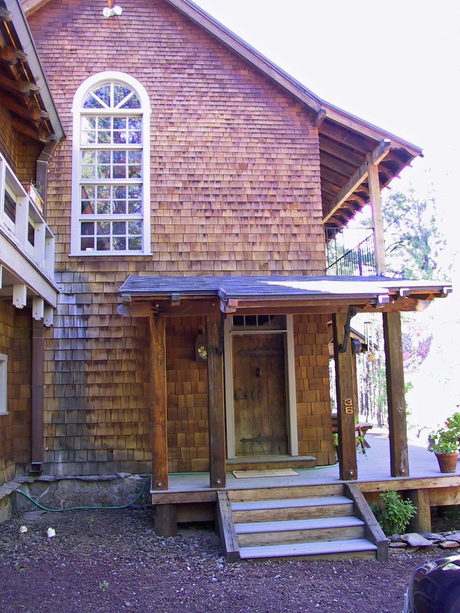 A wooden house with a porch and stairs