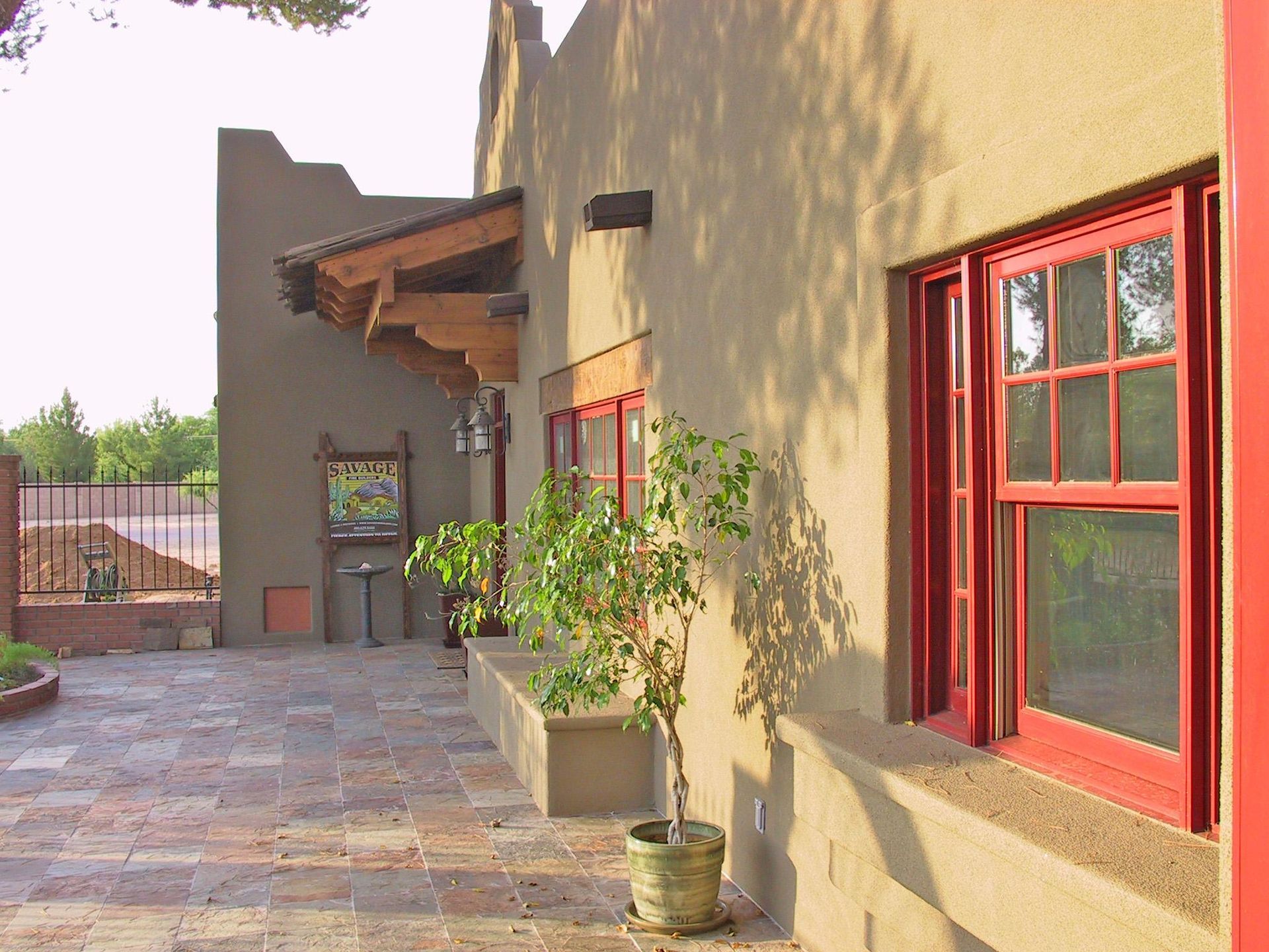A building with red windows and a tree in front of it