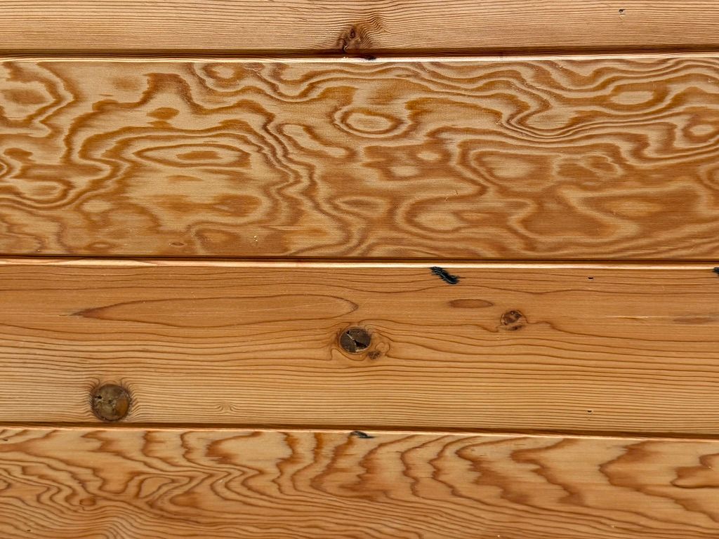 Close-up of light brown wooden planks with visible grain and knots
