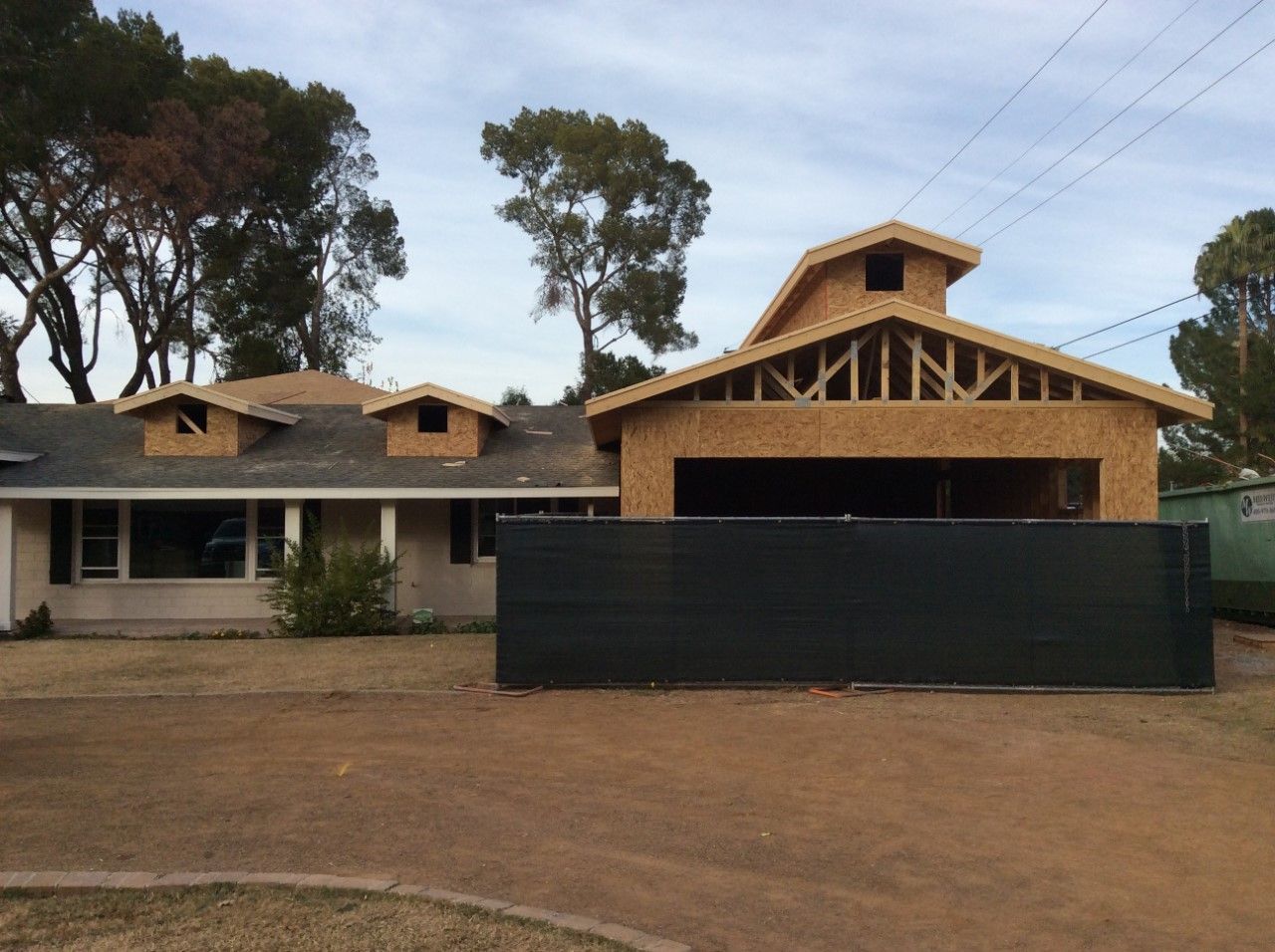 A house under construction with a fence in front of it