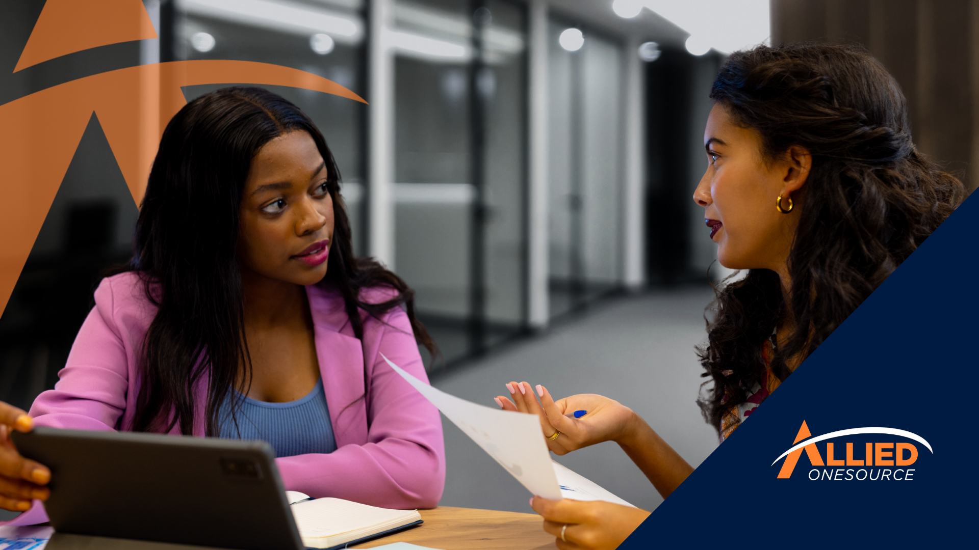 Two women review documents reflecting key salary negotiation tips for women in tech 