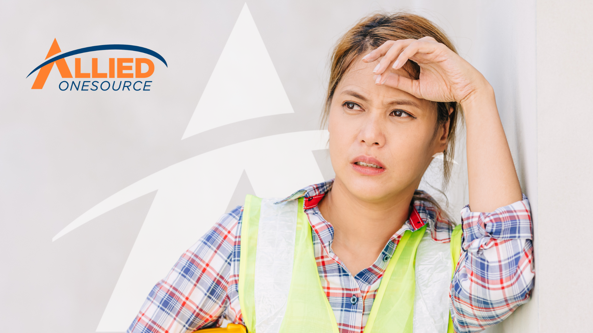Stressed worker in a safety vest  reflecting on toxic workplace signs before accepting a job offrer.