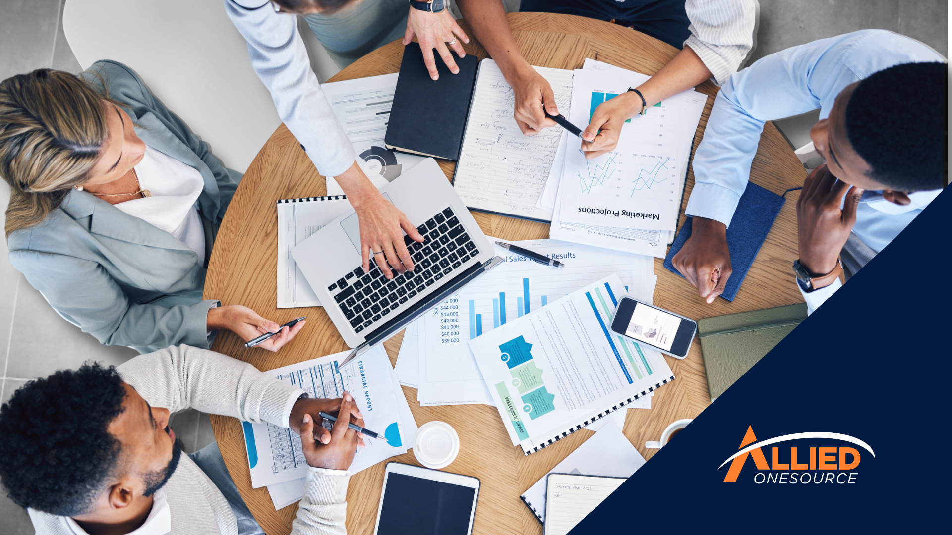 A diverse team reviews financial reports and data charts, reflecting what employers look for.