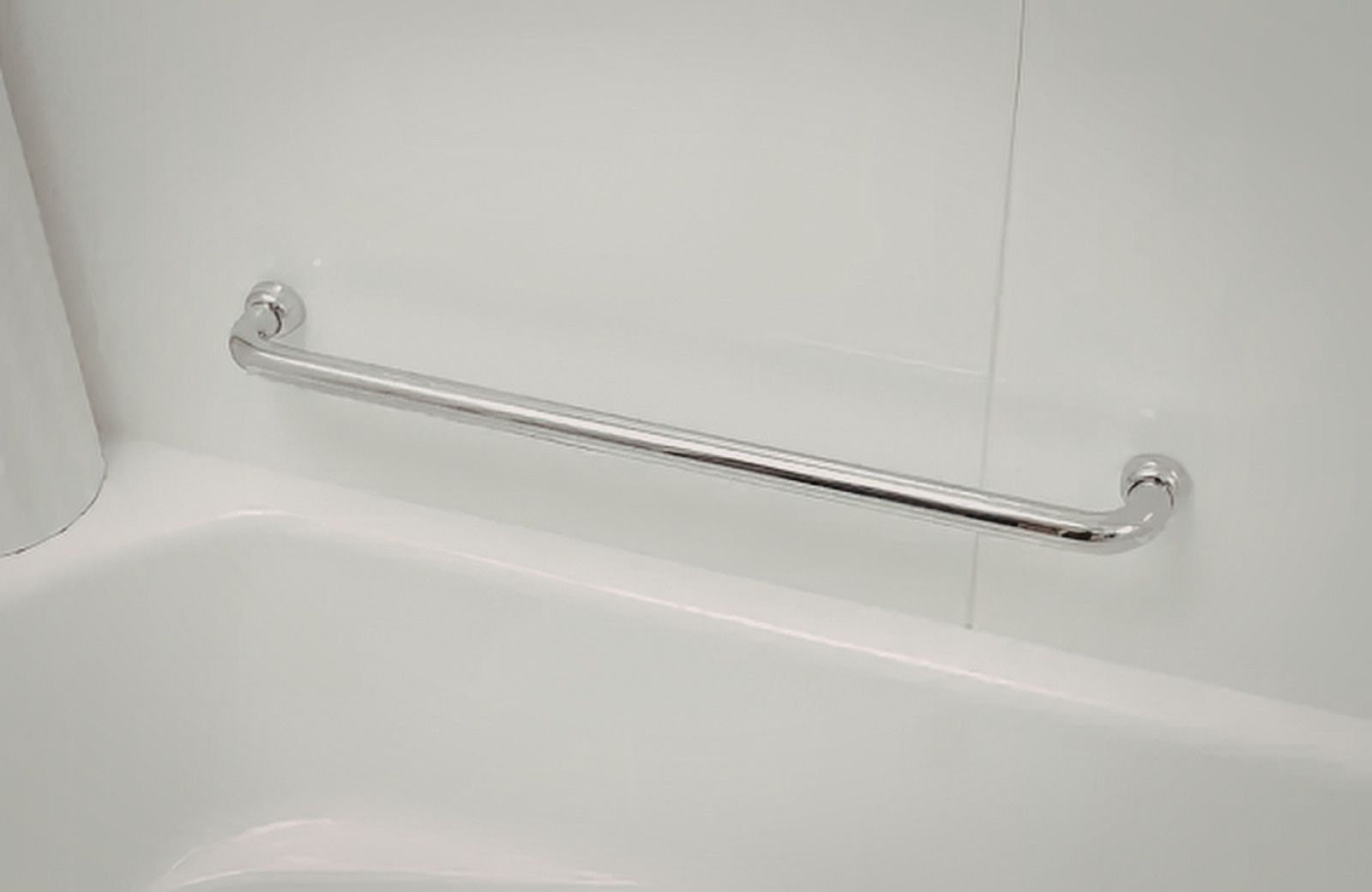 White bathroom grab bar mounted above a tub, with chrome brackets on tiled wall