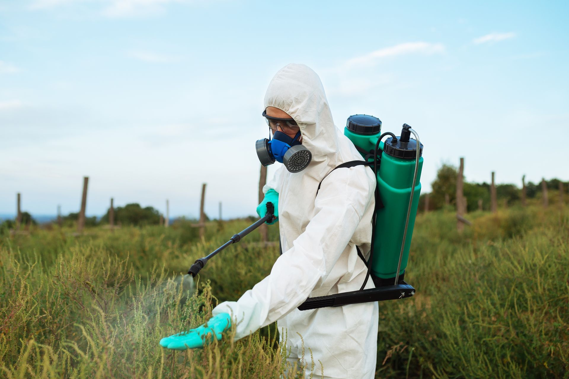 man using pest on the grass