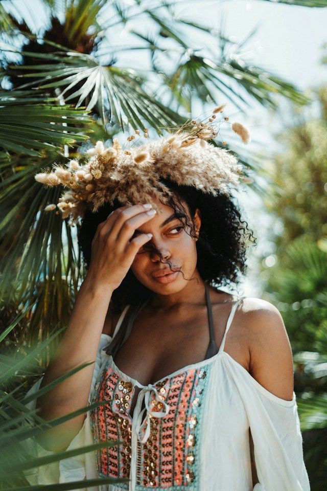a woman with a crown of dried grass on her head