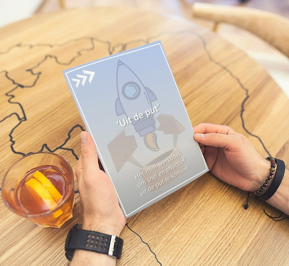 Iemand houdt een boek vast met de tekst "uit de pur"