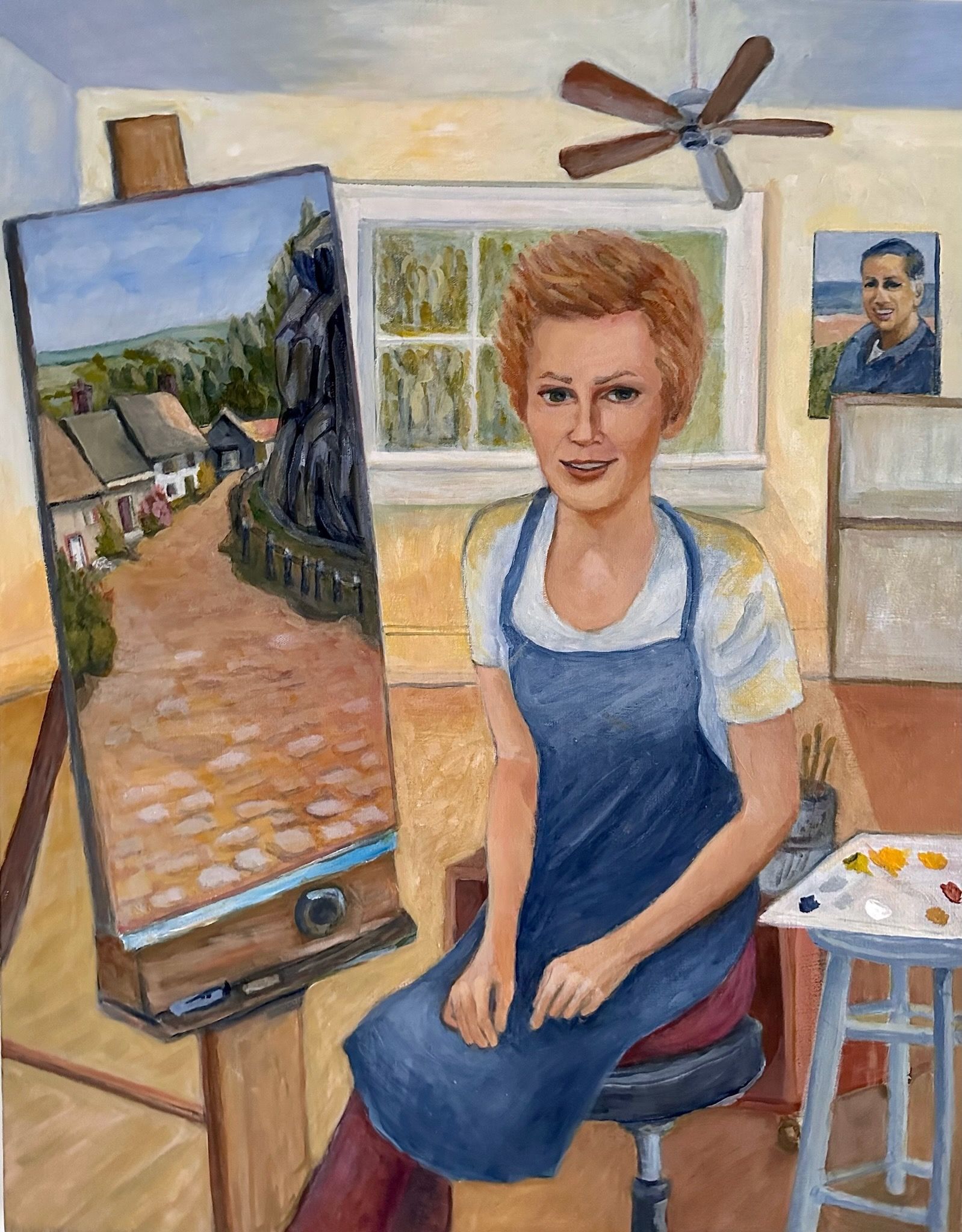 Portrait of a seated woman painting by an easel in a bright studio, with a fan and small table nearby