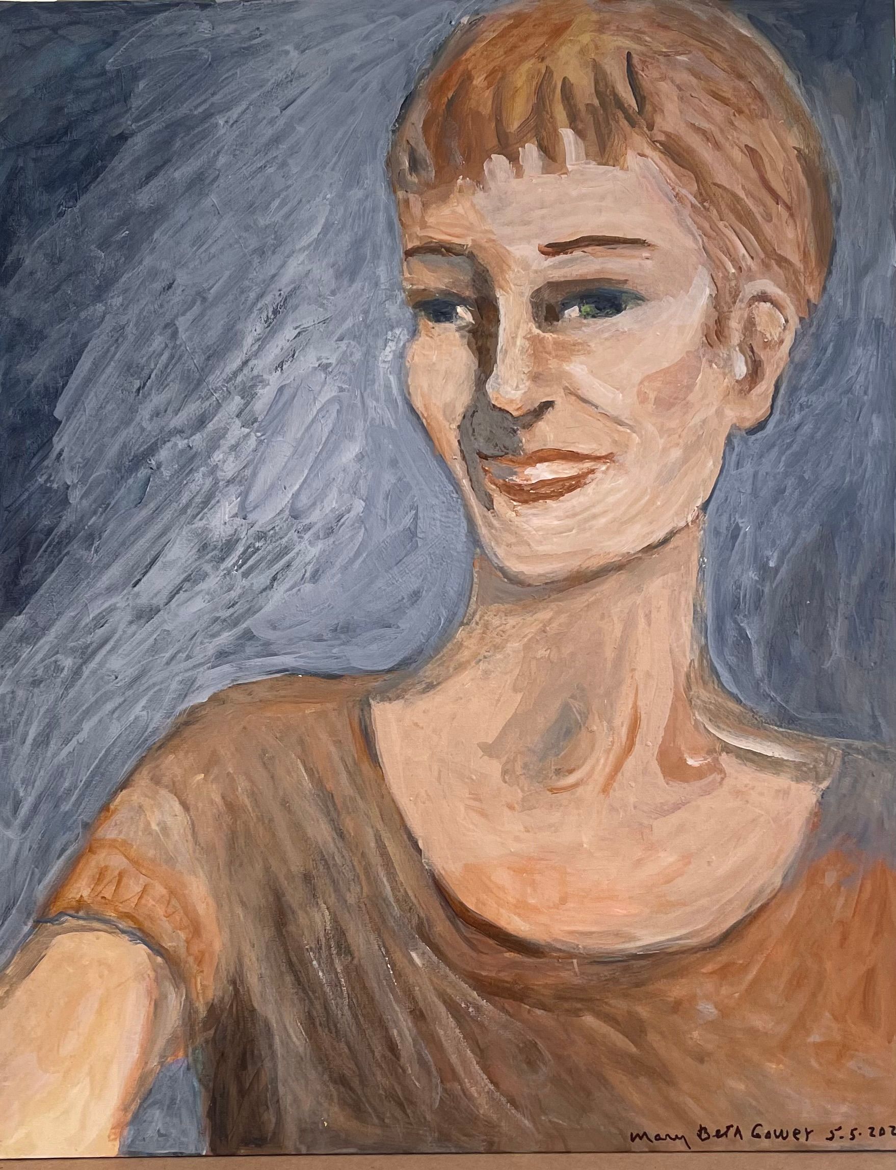 Portrait of a person with short hair and a brown shirt on a blue-gray background