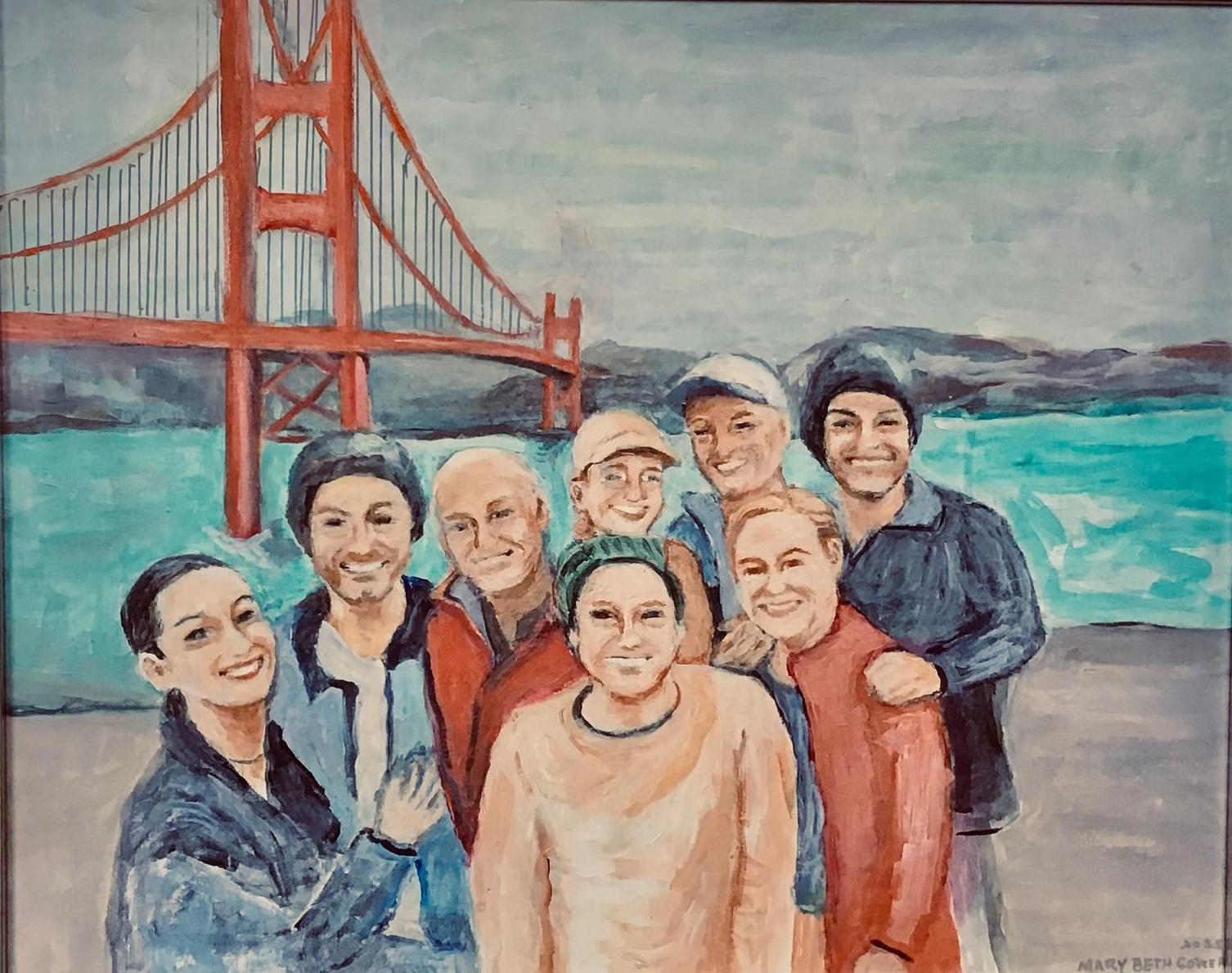 Seven people posing by the Golden Gate Bridge with turquoise water in the background.