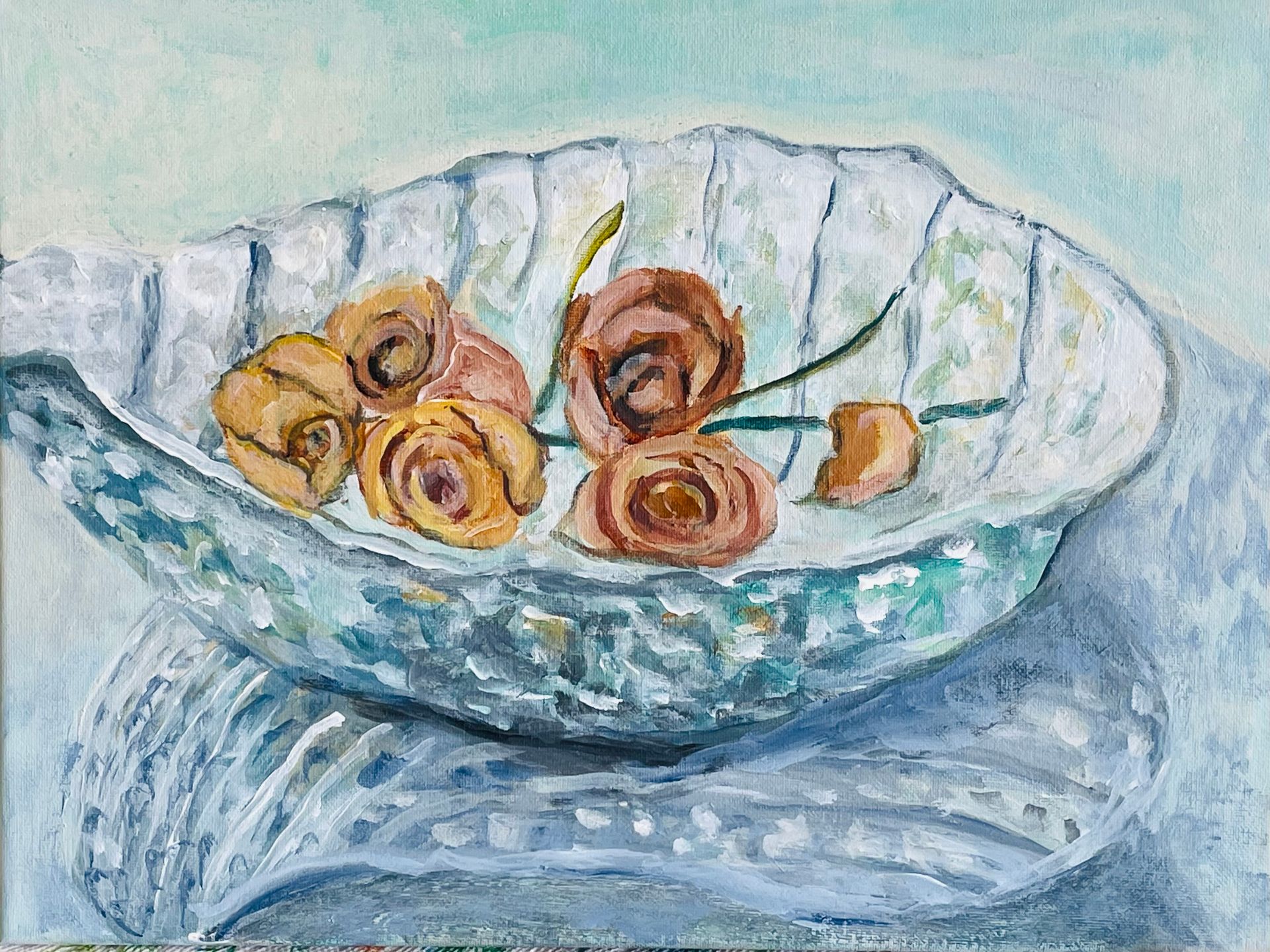 White dish with orange roses on a blue patterned tablecloth