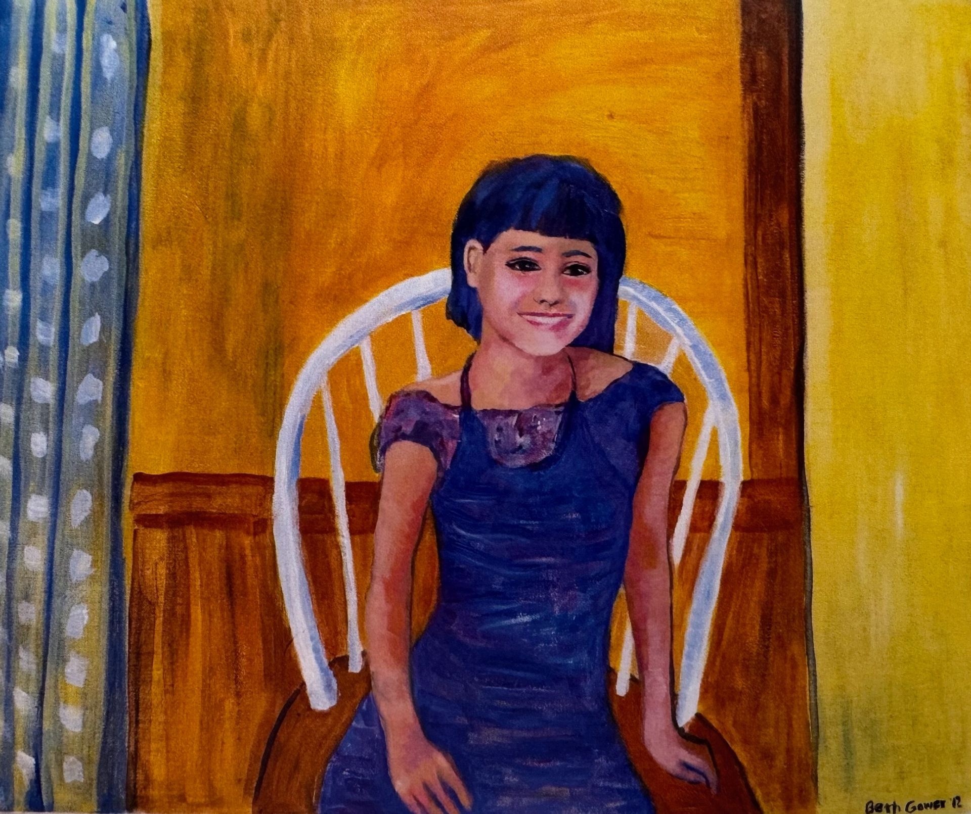 Smiling child seated on a white chair against a warm yellow and orange painted background