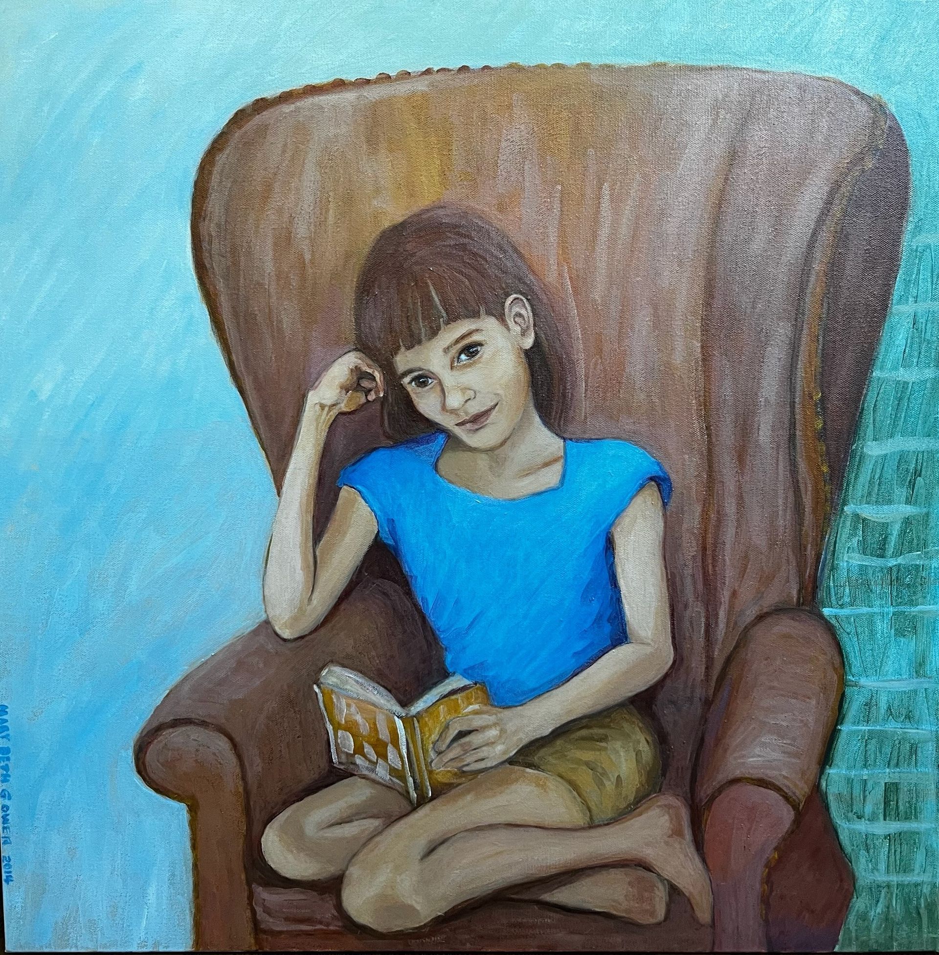 Woman in a blue shirt sits in a brown armchair, reading a book with a relaxed expression.