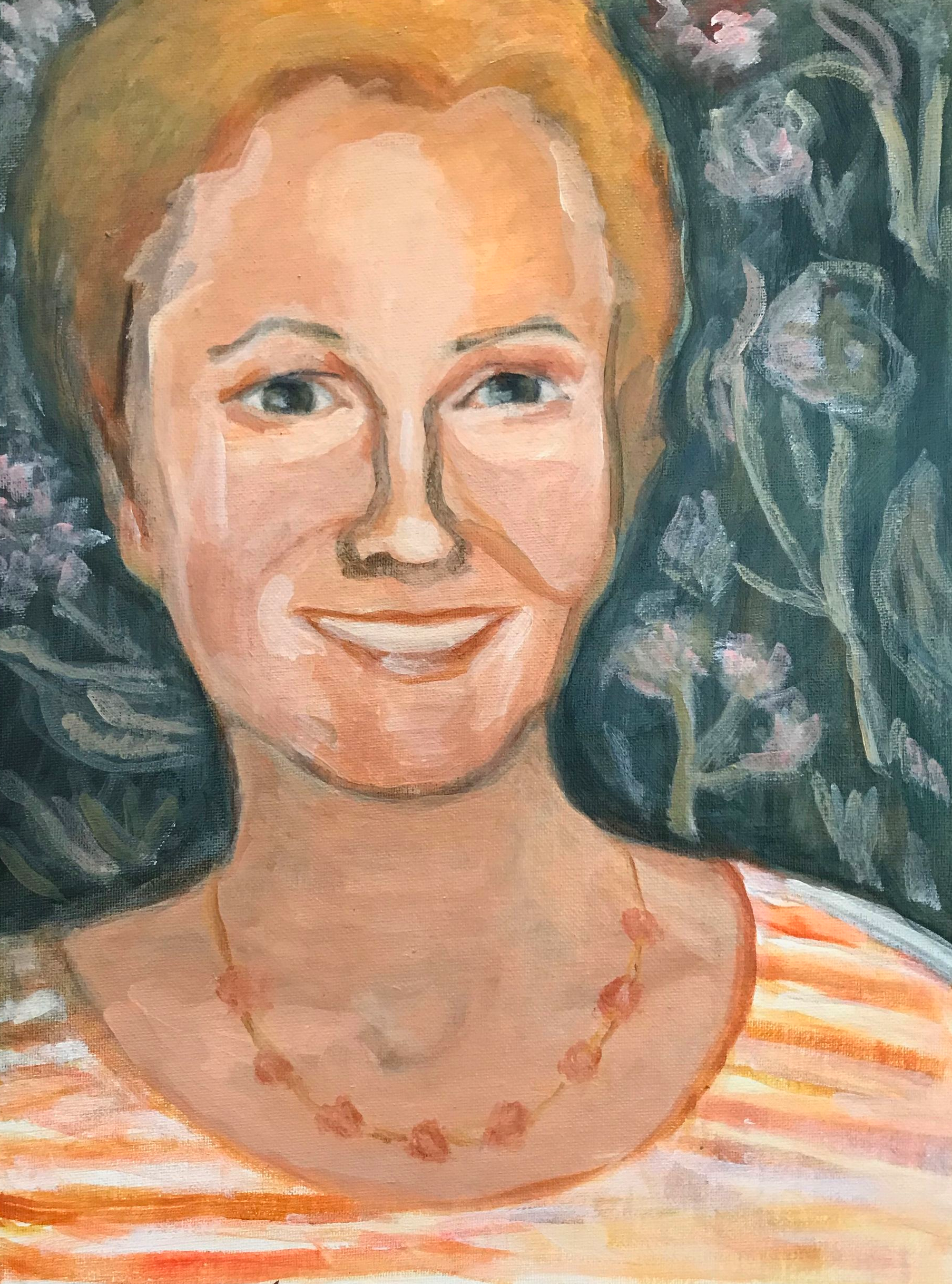 Portrait of a smiling person with blond hair, striped shirt, and beaded necklace against a dark leafy background