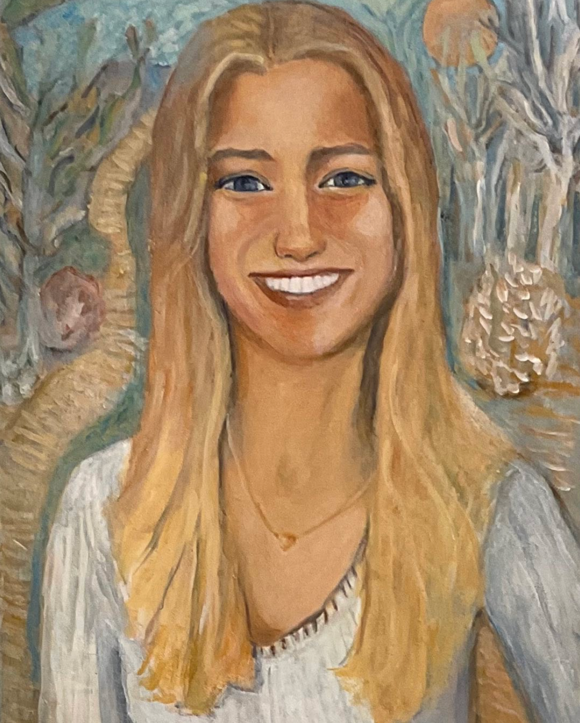 Smiling blonde woman in a white top against a soft floral background