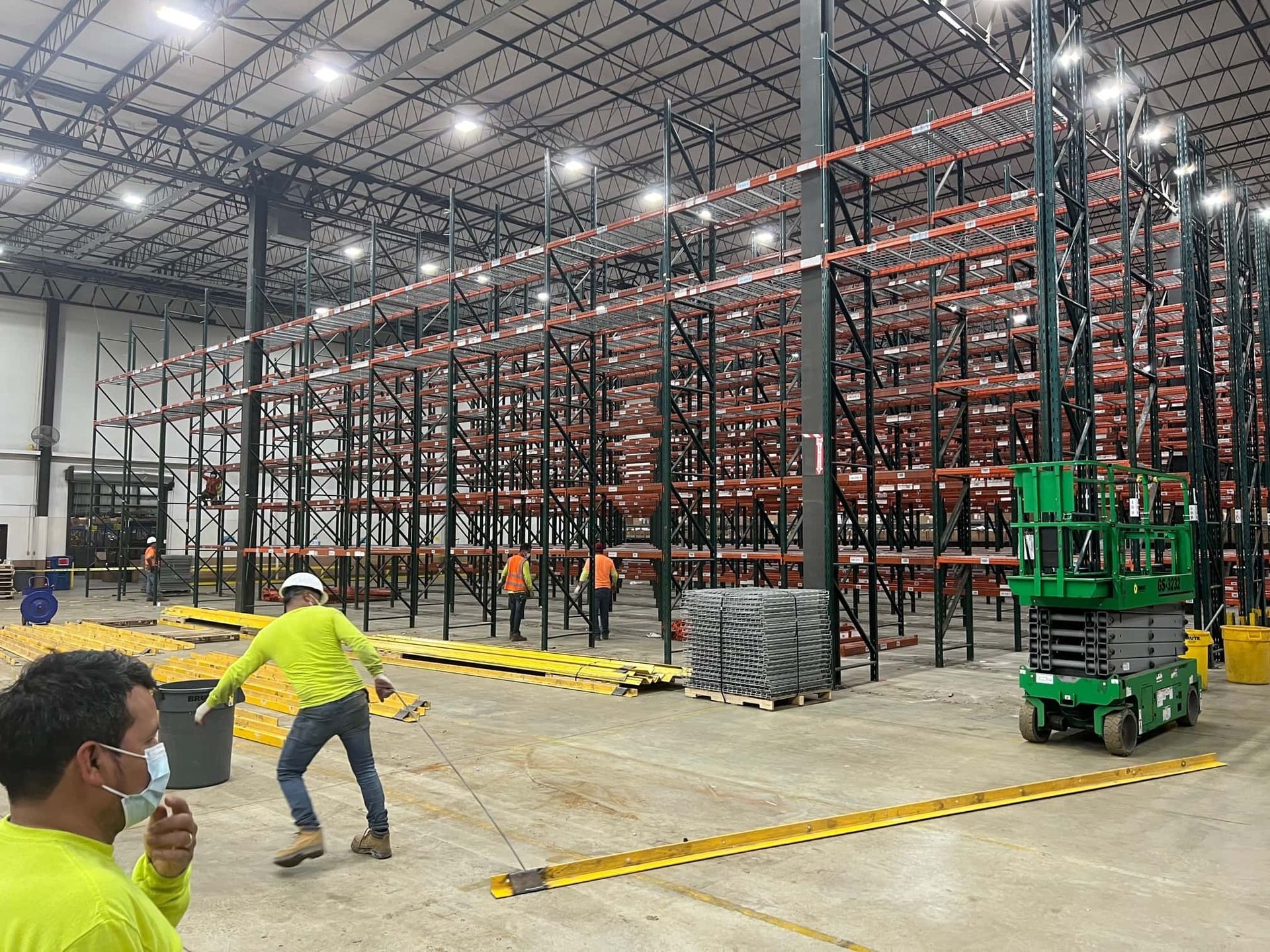 Professional crew assembling heavy-duty shelving for pallet rack installation.