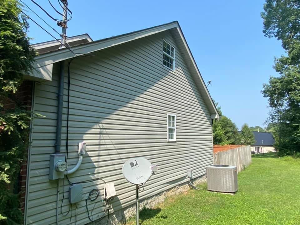 A house with a satellite dish on the side of it.