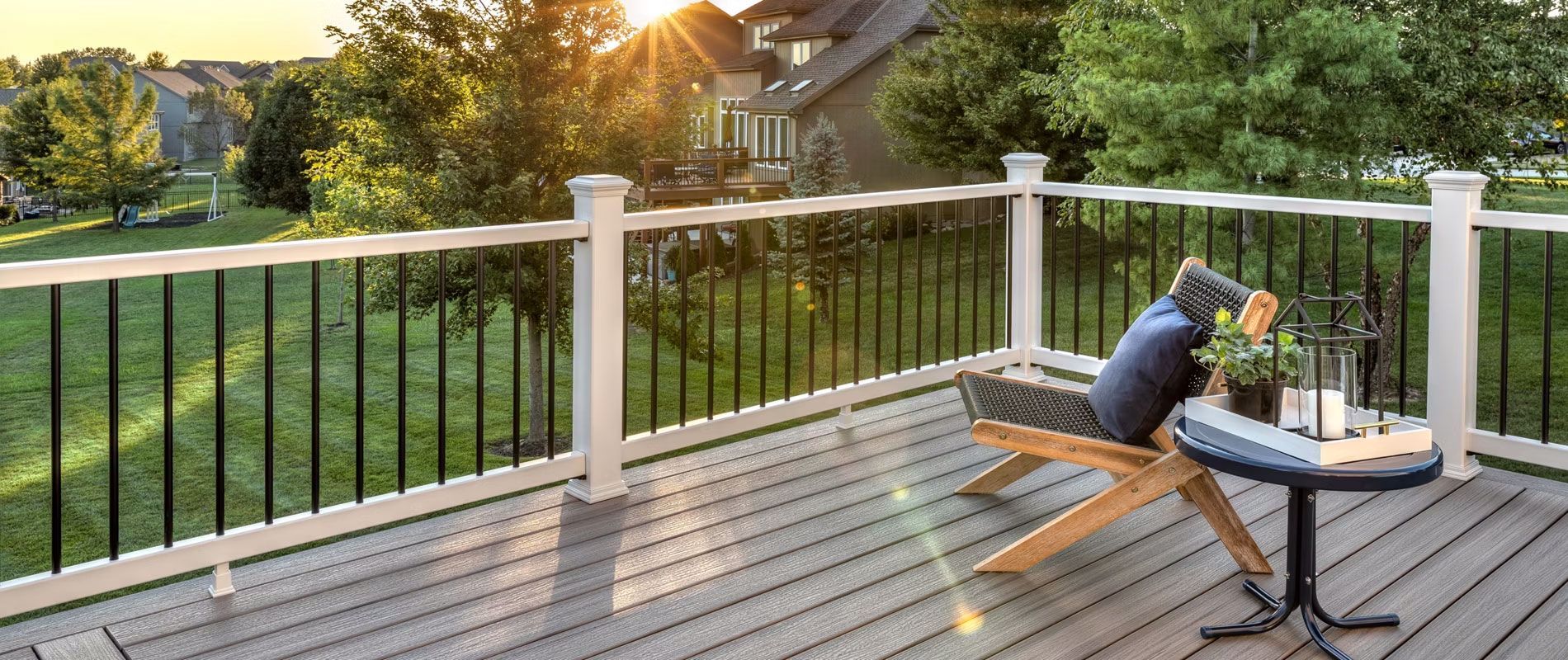 A composite deck with custom railings and a chair and a table on it in Bellefonte. 