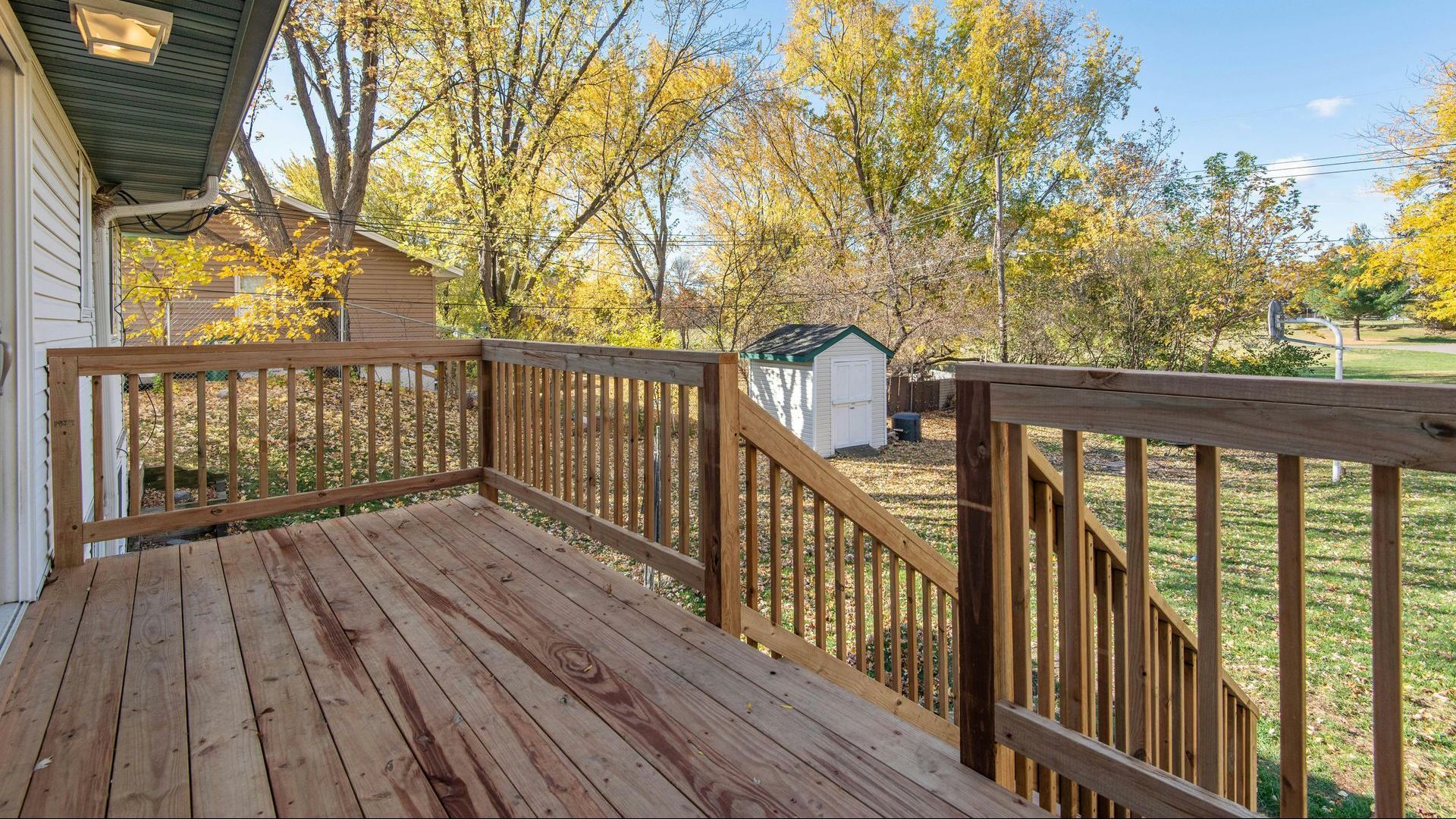 There is a wooden deck with stairs leading up to it.