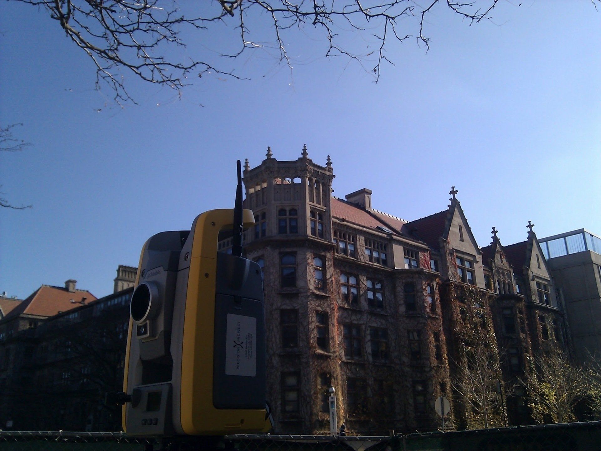 A large building with a yellow and black object in front of it