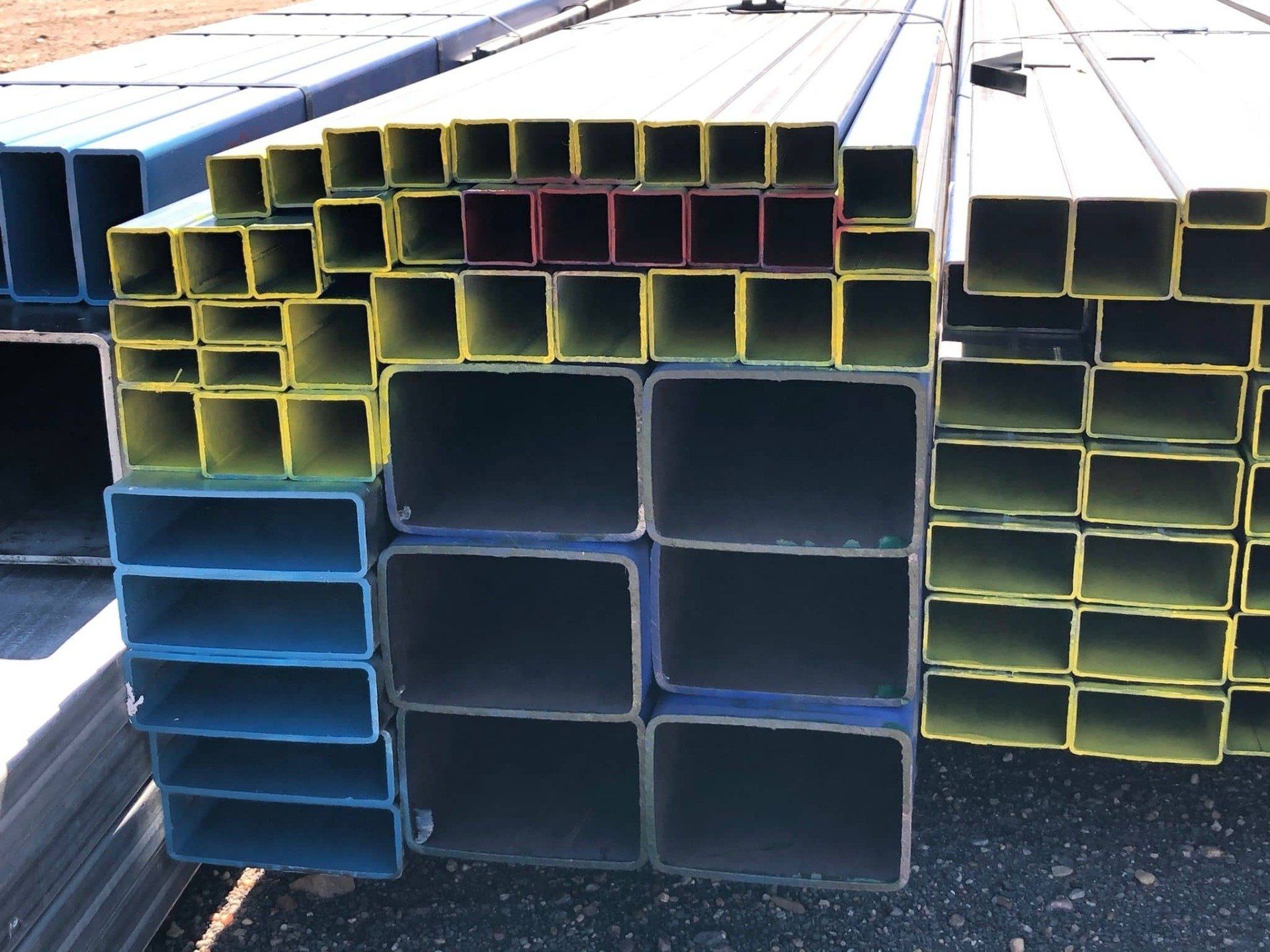 Colourful Square Steel Poles Stacked — Metal Mates in Maitland, NSW