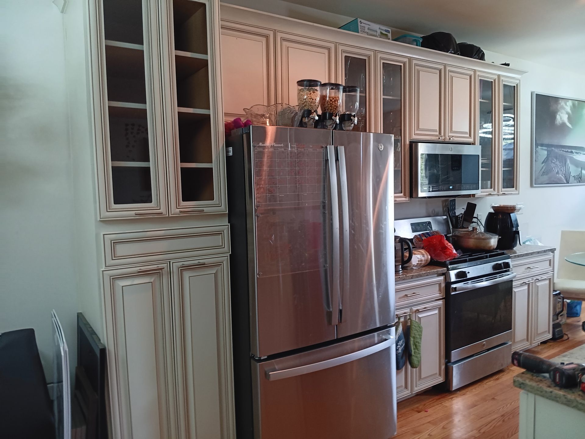 Kitchen with a stainless steel refrigerator, cabinets, and an oven.