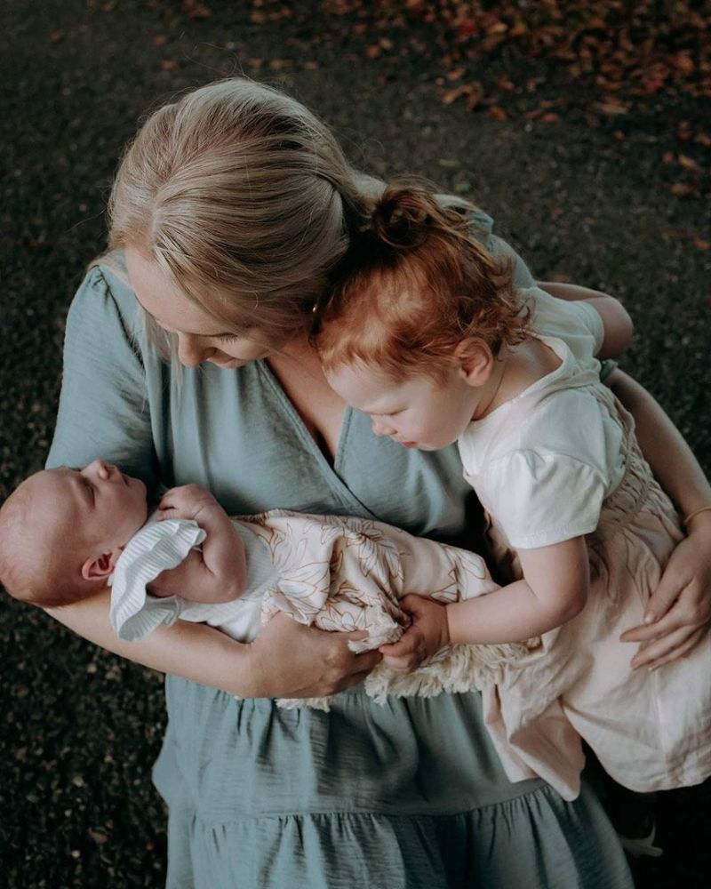 A Woman Is Holding a Newborn Baby and A Little Girl — Seed + Salt Photography In Foster, NSW