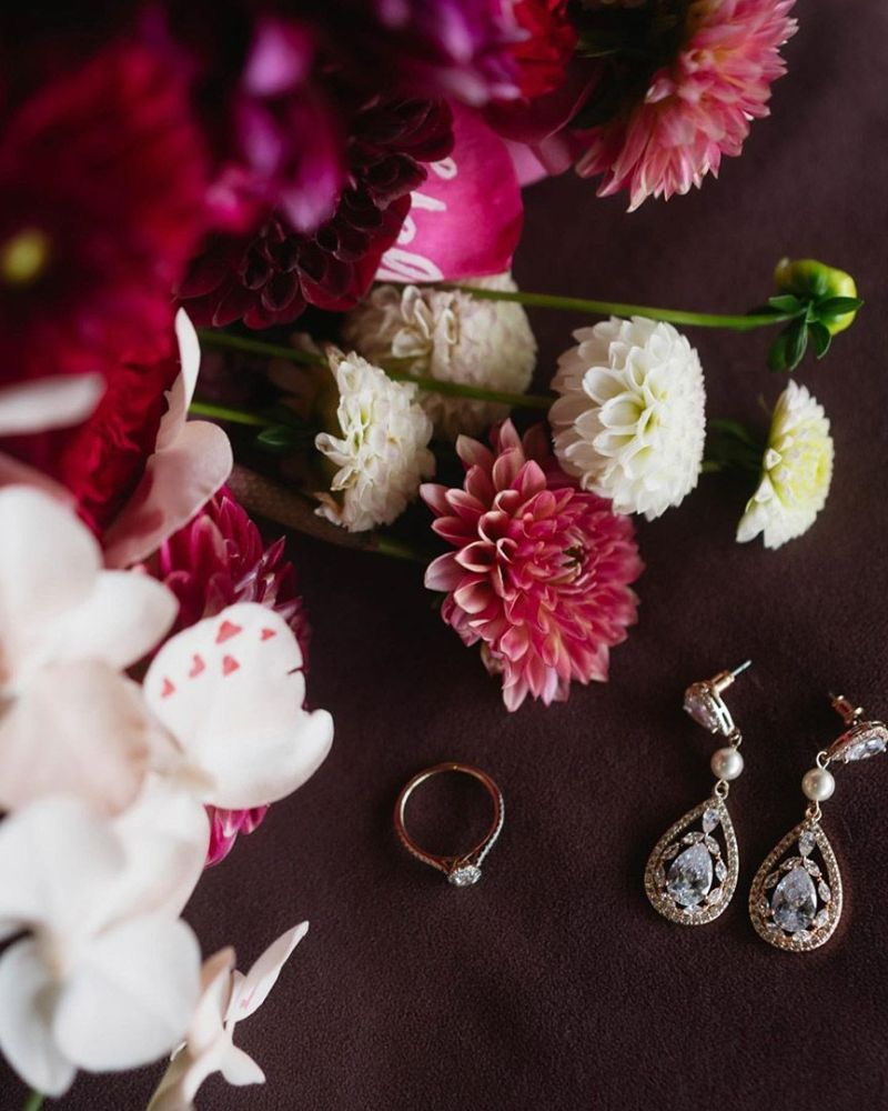 A Ring and Earrings Are Sitting Next to A Bouquet of Flowers — Seed + Salt Photography In Taree, NSW