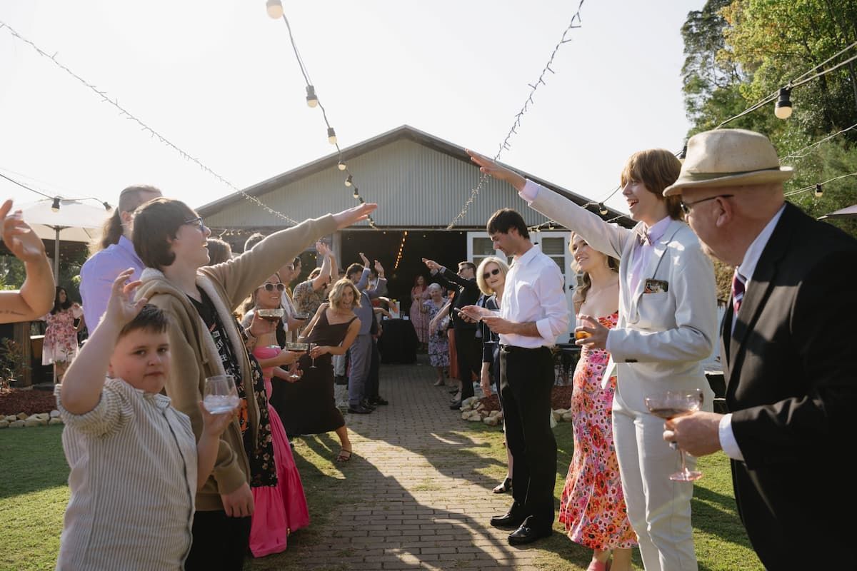 People Raising Cups at an Outdoor Celebration โ Seed + Salt Photography In Smithtown, NSW