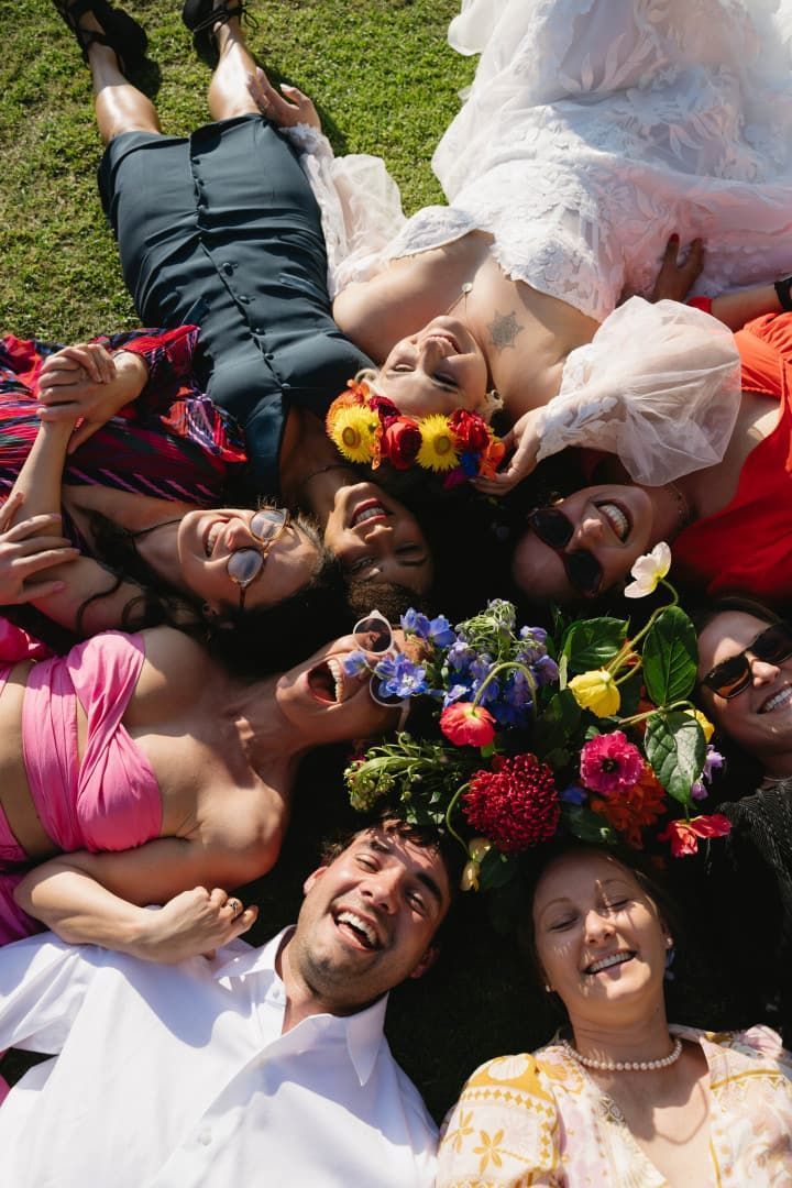 People Lying in a Circle on Grass, Smiling and Holding Colorful Flowers โ Seed + Salt Photography In Smithtown, NSW