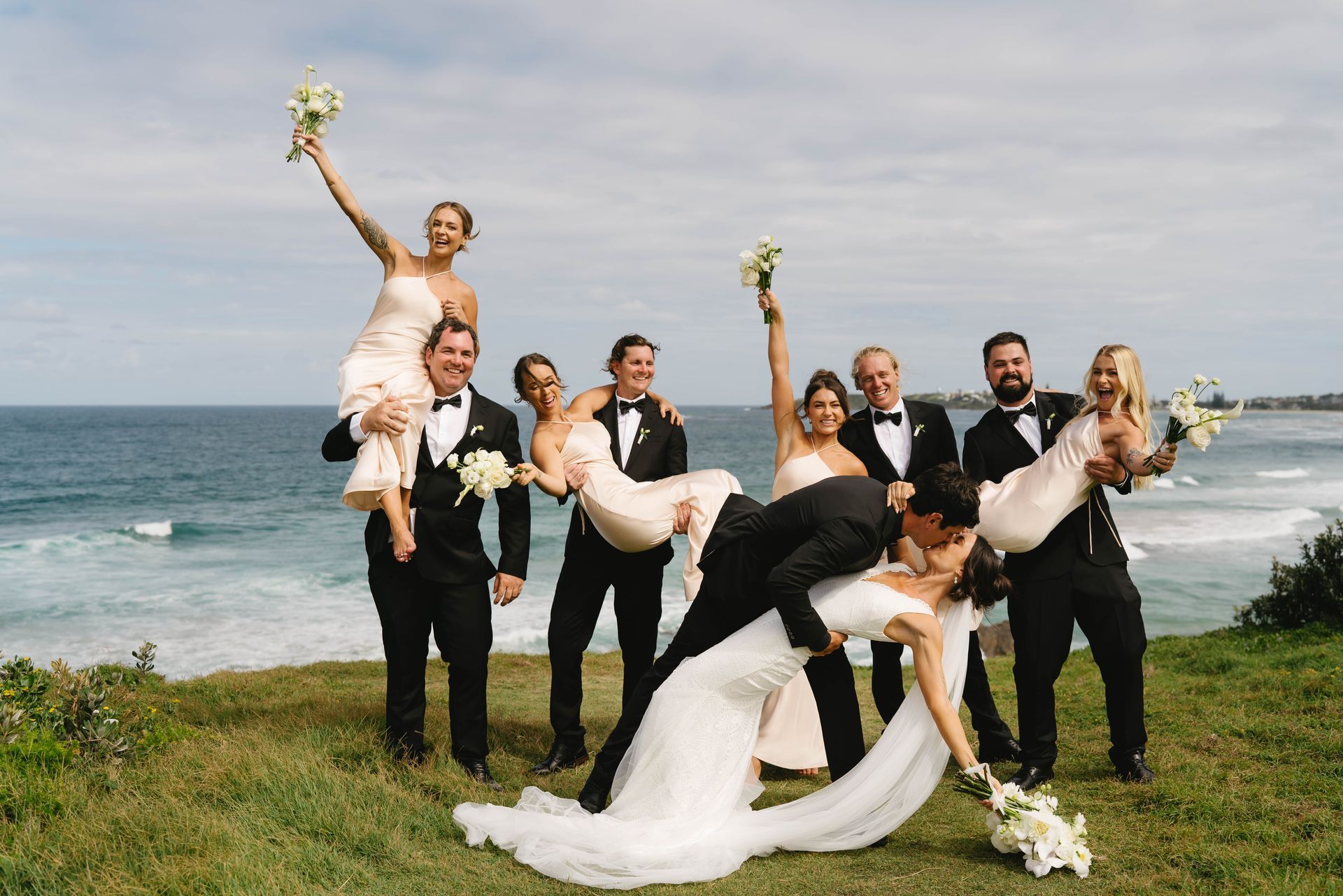 A Bride and Groom at Their Wedding with bridal party running around them— Seed + Salt Photography In Smithtown, NSW