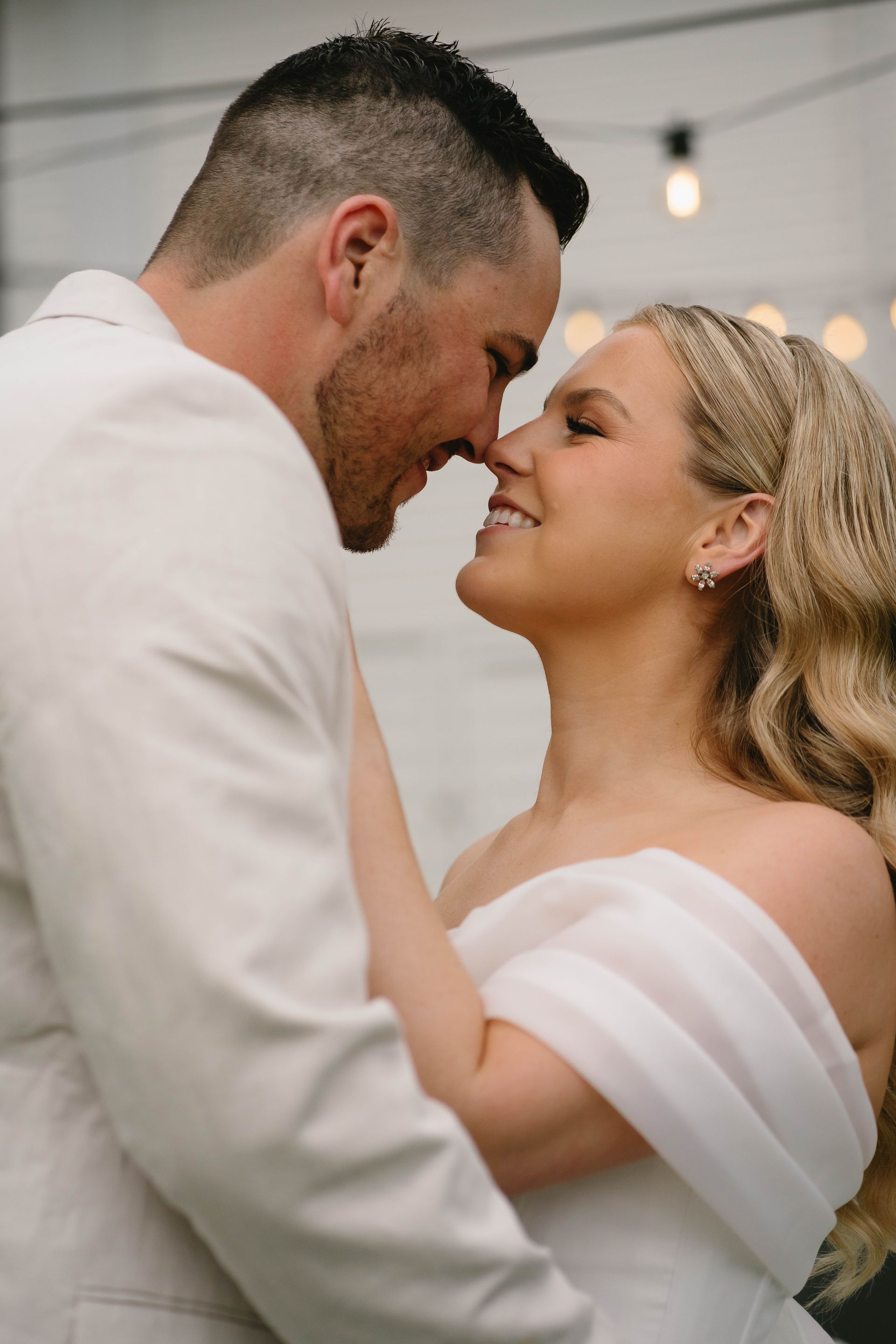 A Man and A Woman Are Hugging and Kissing on The Beach — Seed + Salt Photography In Smithtown, NSW
