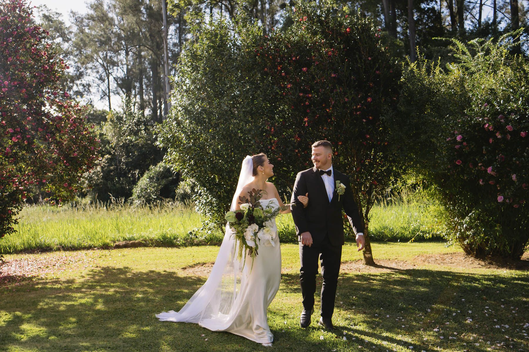 A Bride and Groom Are Looking into Each Others Eyes Under an Umbrella— Seed + Salt Photography In Smithtown, NSW