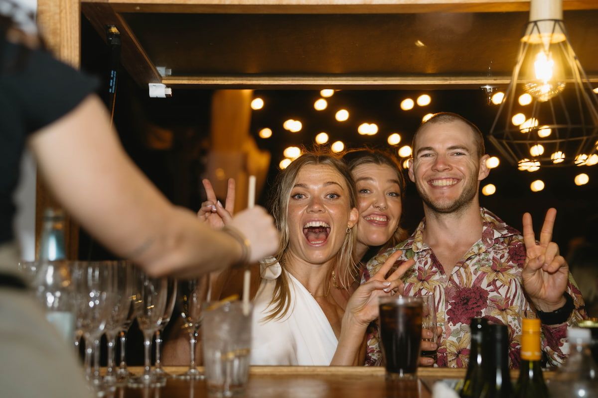 Friends Smiling and Cheering at a Bar โ Seed + Salt Photography In Smithtown, NSW