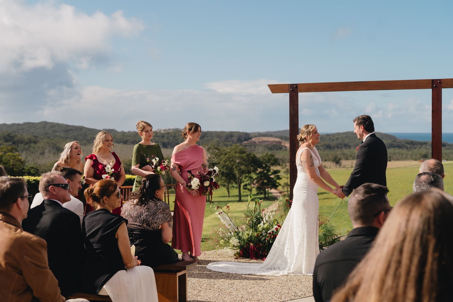  A Bride and Groom at Their Wedding with bridal party running around them— Seed + Salt Photography In Smithtown, NSW