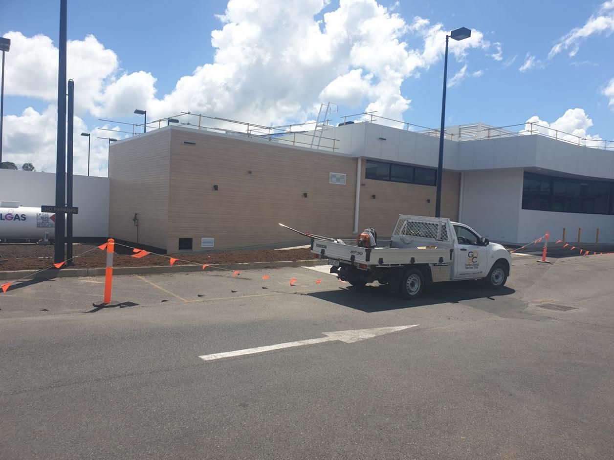 A White Truck Is Parked in Front of A Building Under Construction — Gillespie Plumbing in Grafton, NSW