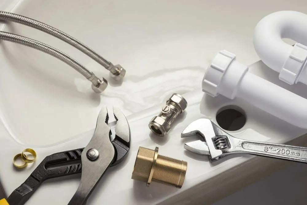A Sink with A Wrench and Pliers on It — Gillespie Plumbing in Grafton, NSW