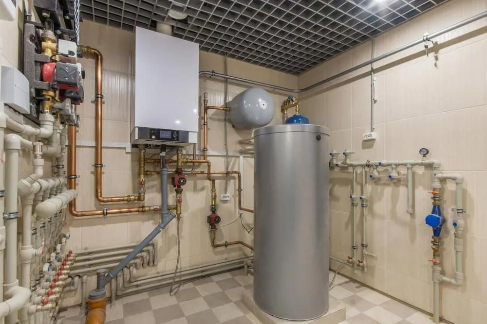 A Room with A Boiler and A Water Heater in It — Gillespie Plumbing in Grafton, NSW