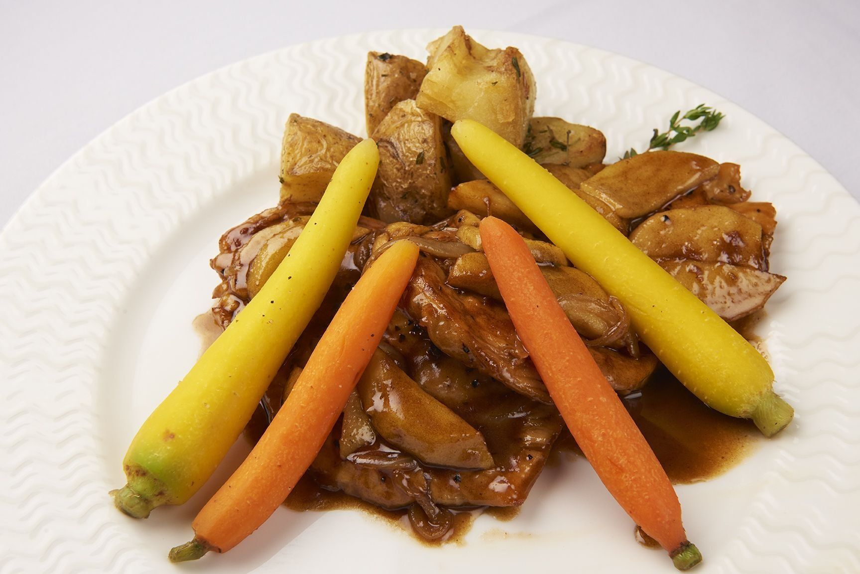 Chicken Normandy A plate of food with carrots and potatoes on it