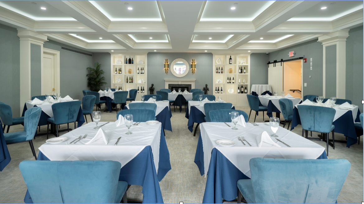 A large dining room with blue chairs and tables