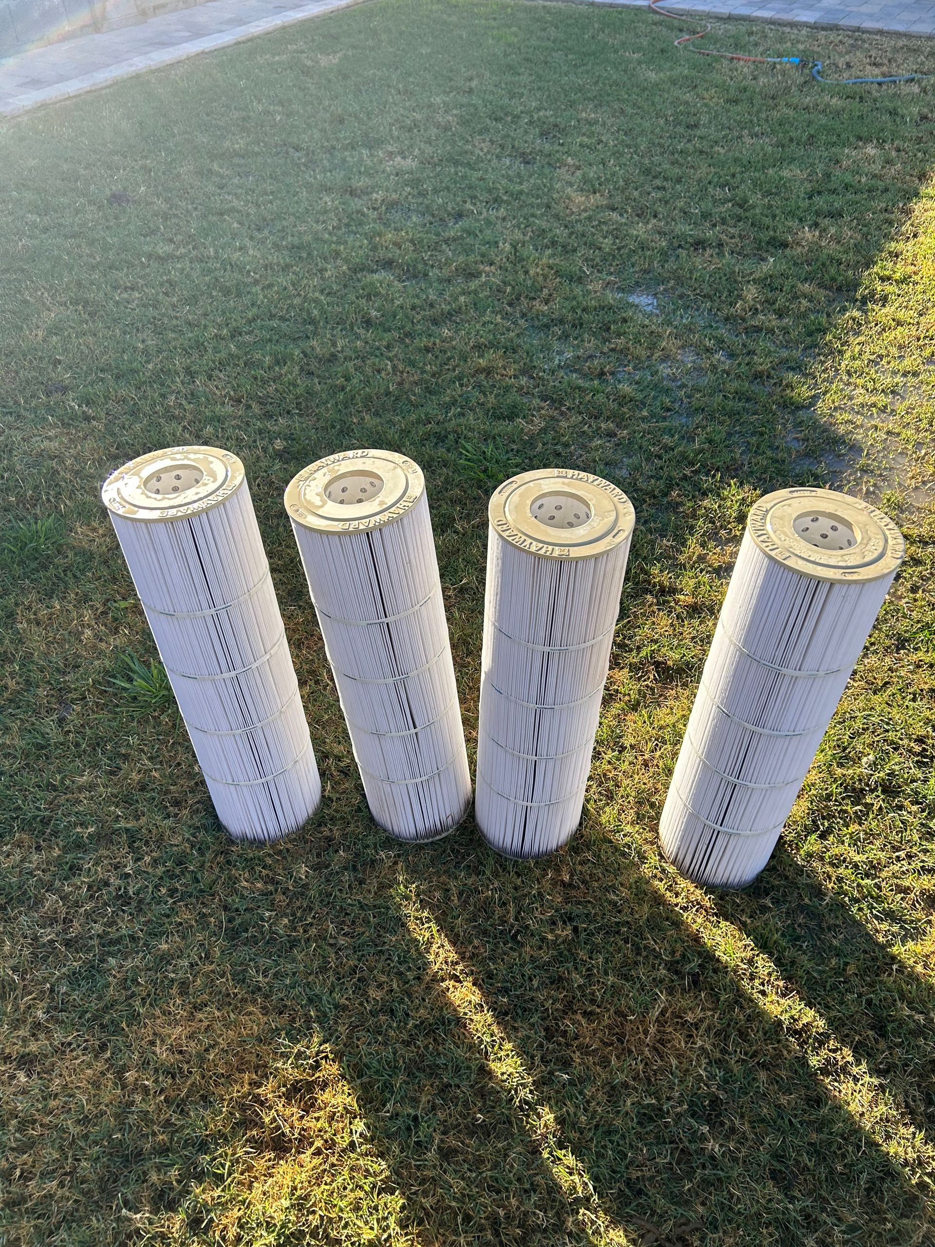 Person removing a filter bag from a pool skimmer.